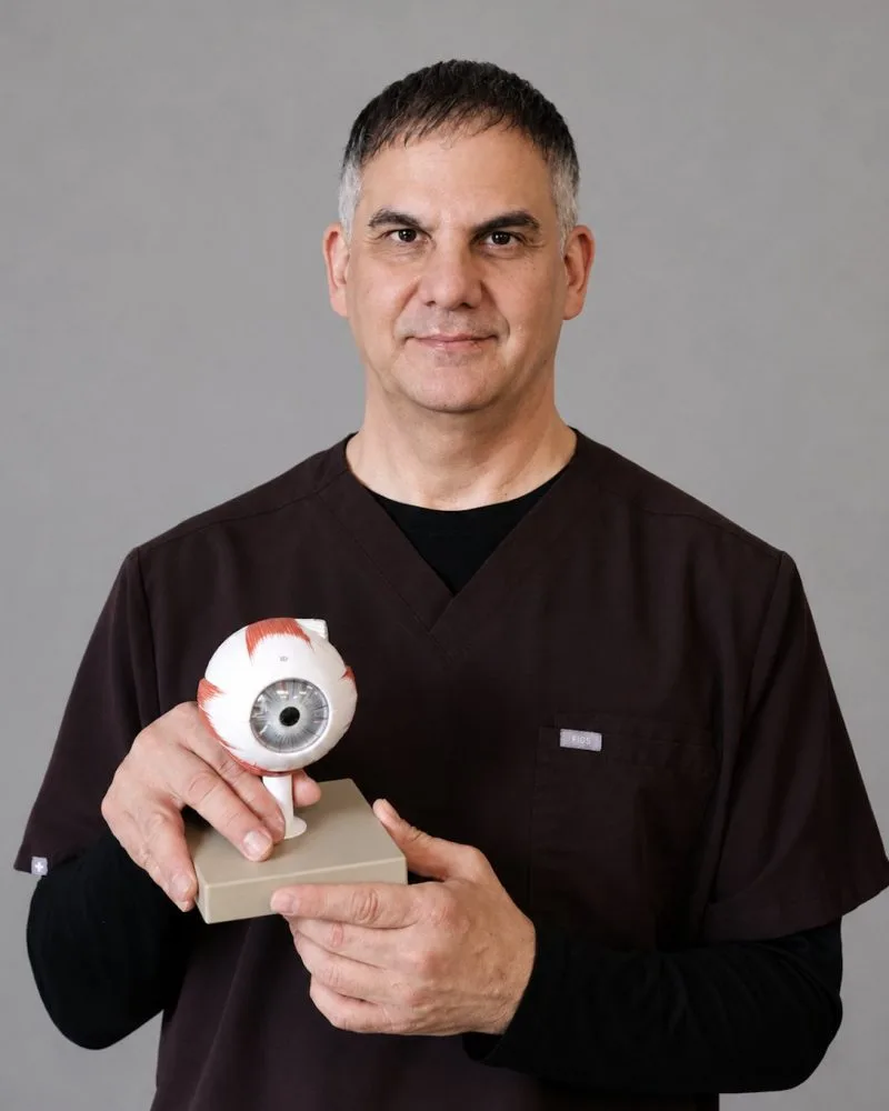 Dr. Gary Blackburn, DC FACFN, holding an anatomical model of the eye