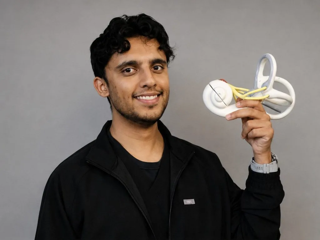 Dr. Sam Jyotishi, DC, holding an anatomical model of the inner ear